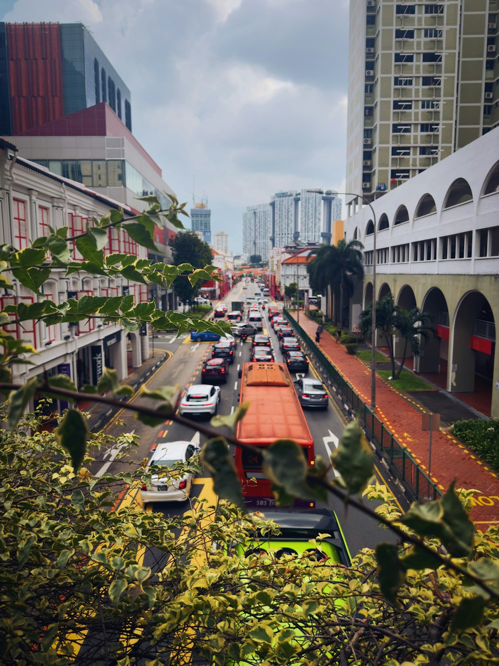 a street filled with lots of traffic next to tall buildings