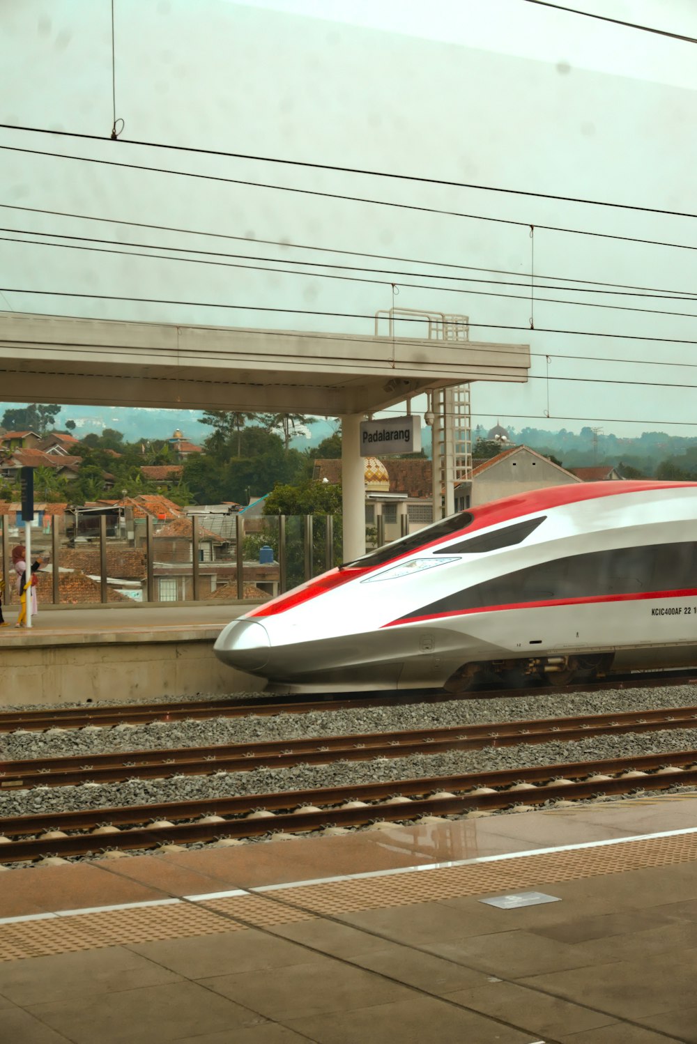 a white and red train traveling down train tracks