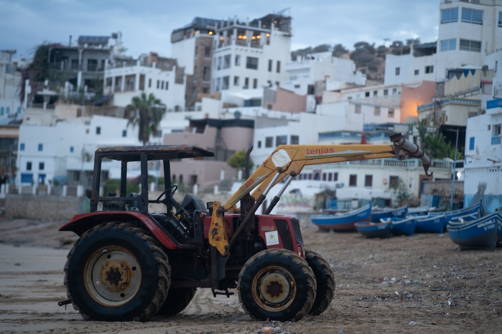a bulldozer is parked on the beach in front of a city