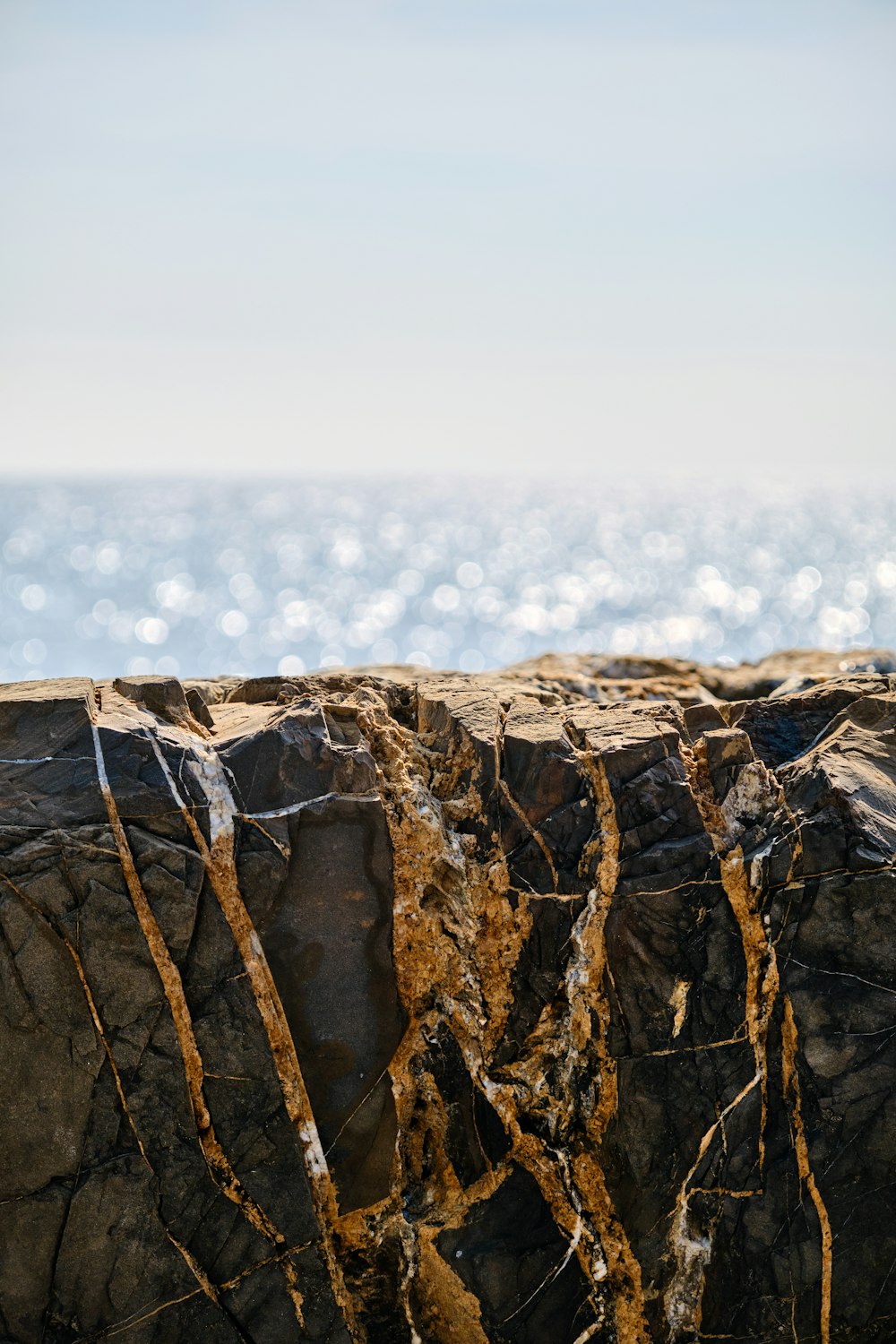 a close up of rocks with water in the background