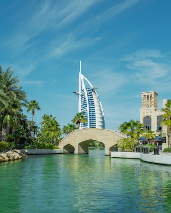 a bridge over a body of water with a building in the background