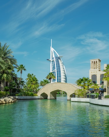a bridge over a body of water with a building in the background