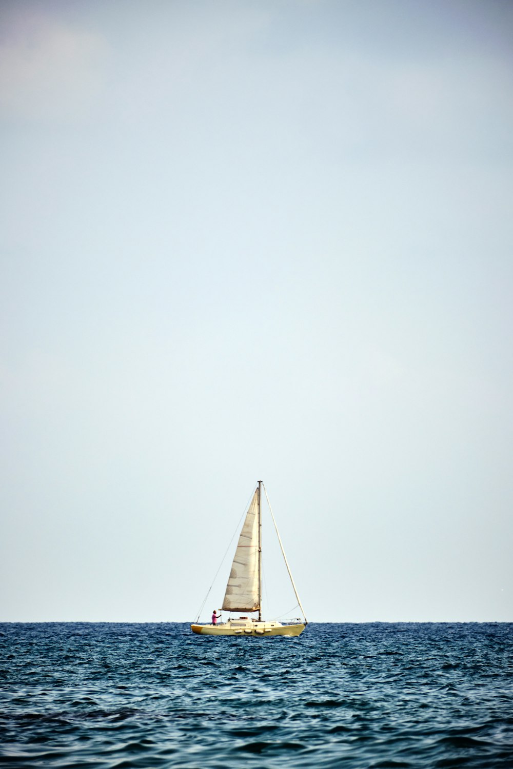 a sailboat in the middle of the ocean