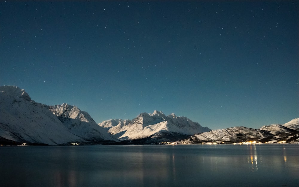 a view of a mountain range with a lake in the foreground