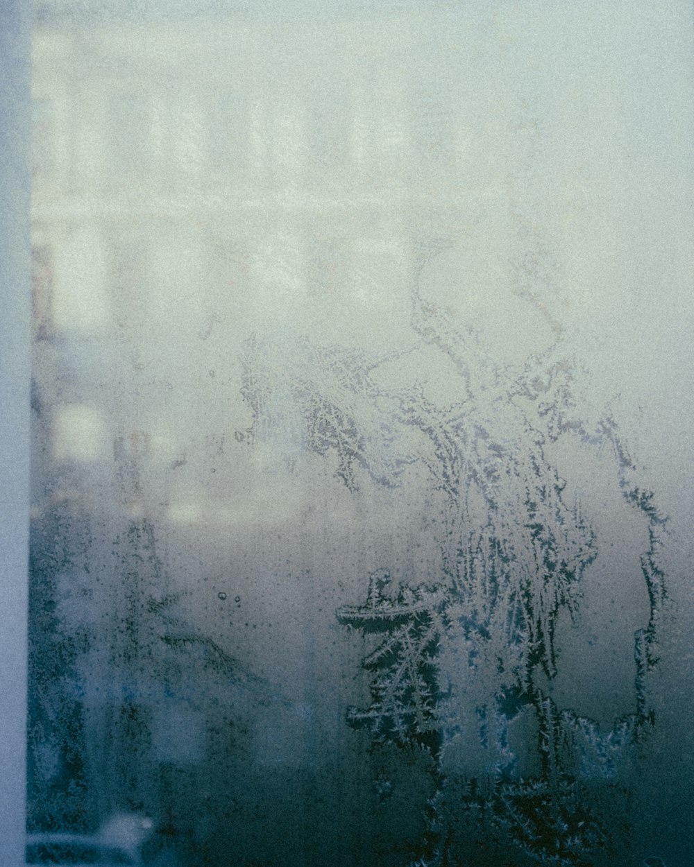 a frosted window with a building in the background