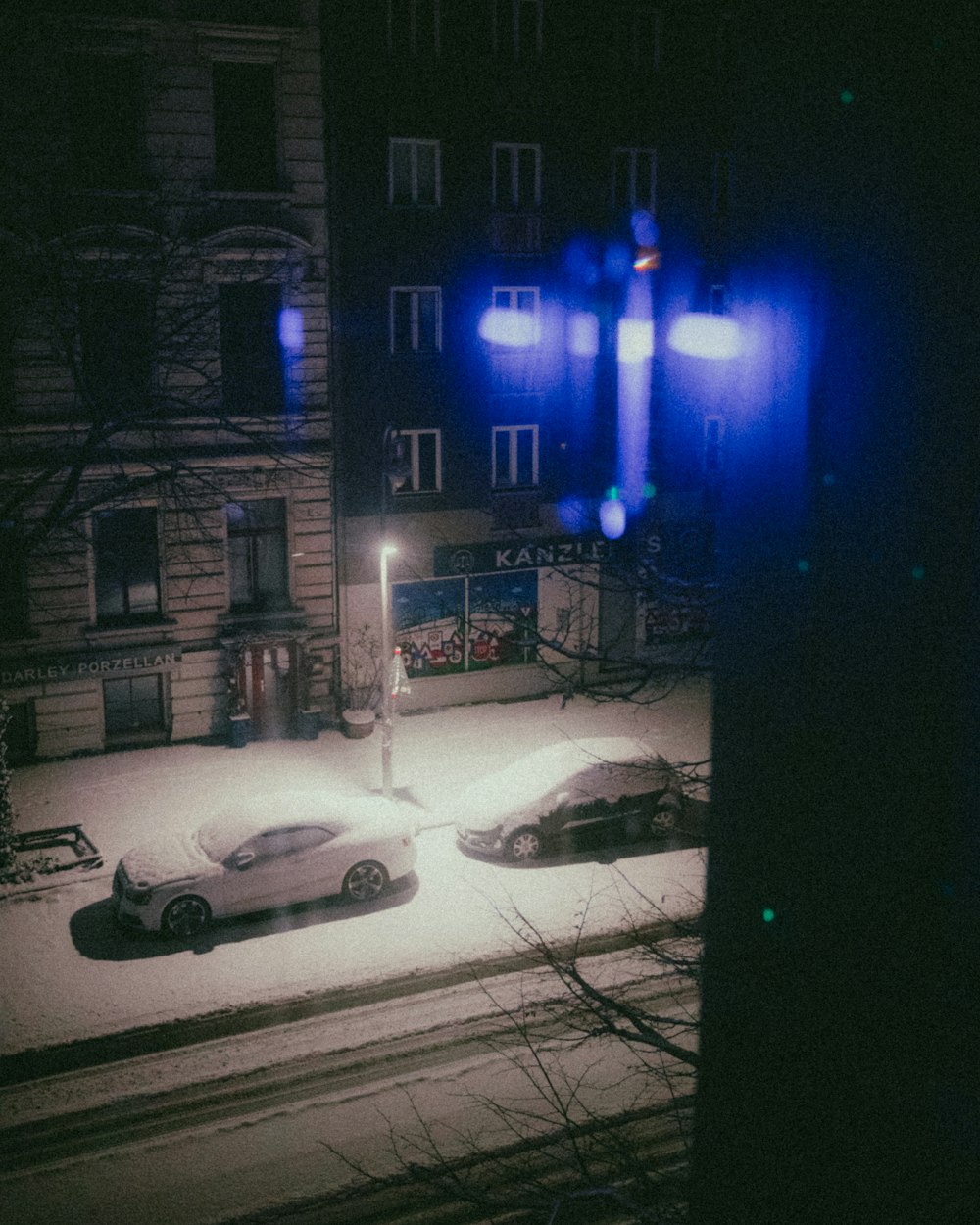 a couple of cars parked in front of a building