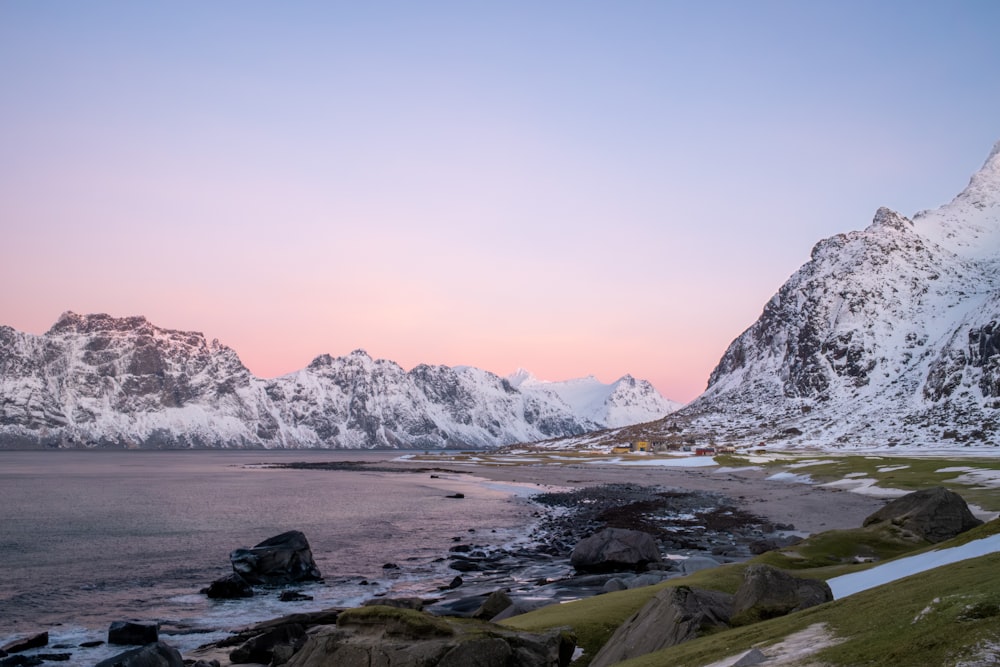 a mountain range with a body of water in the foreground