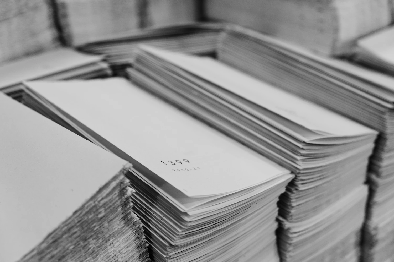 Tight blocks of folded printed sheets stacked and squared off on a worktop