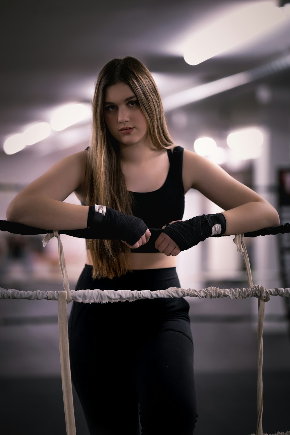 a woman holding a pair of boxing gloves