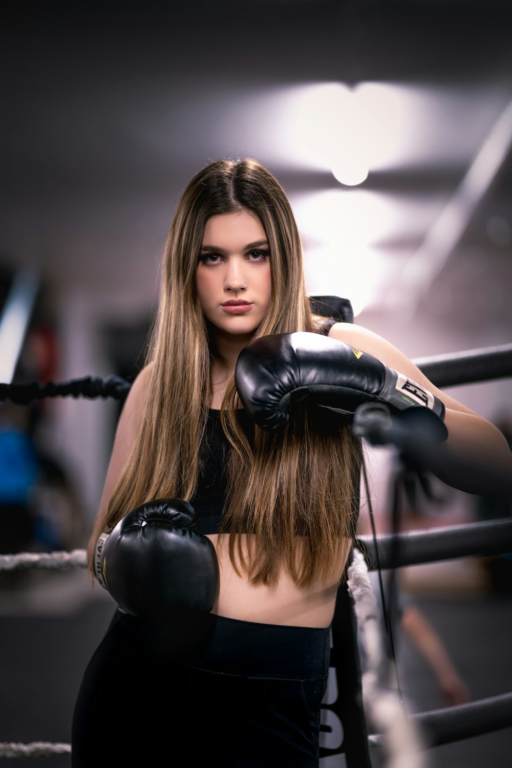a beautiful young woman wearing boxing gloves
