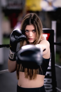 a woman with boxing gloves on posing for a picture