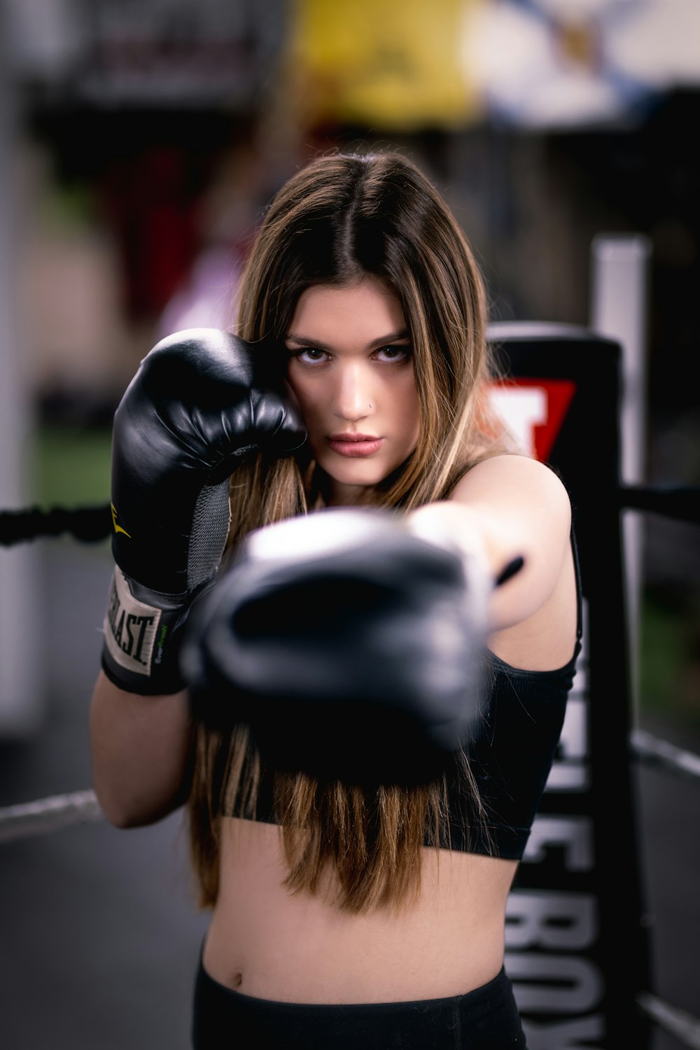 a woman with boxing gloves on posing for a picture