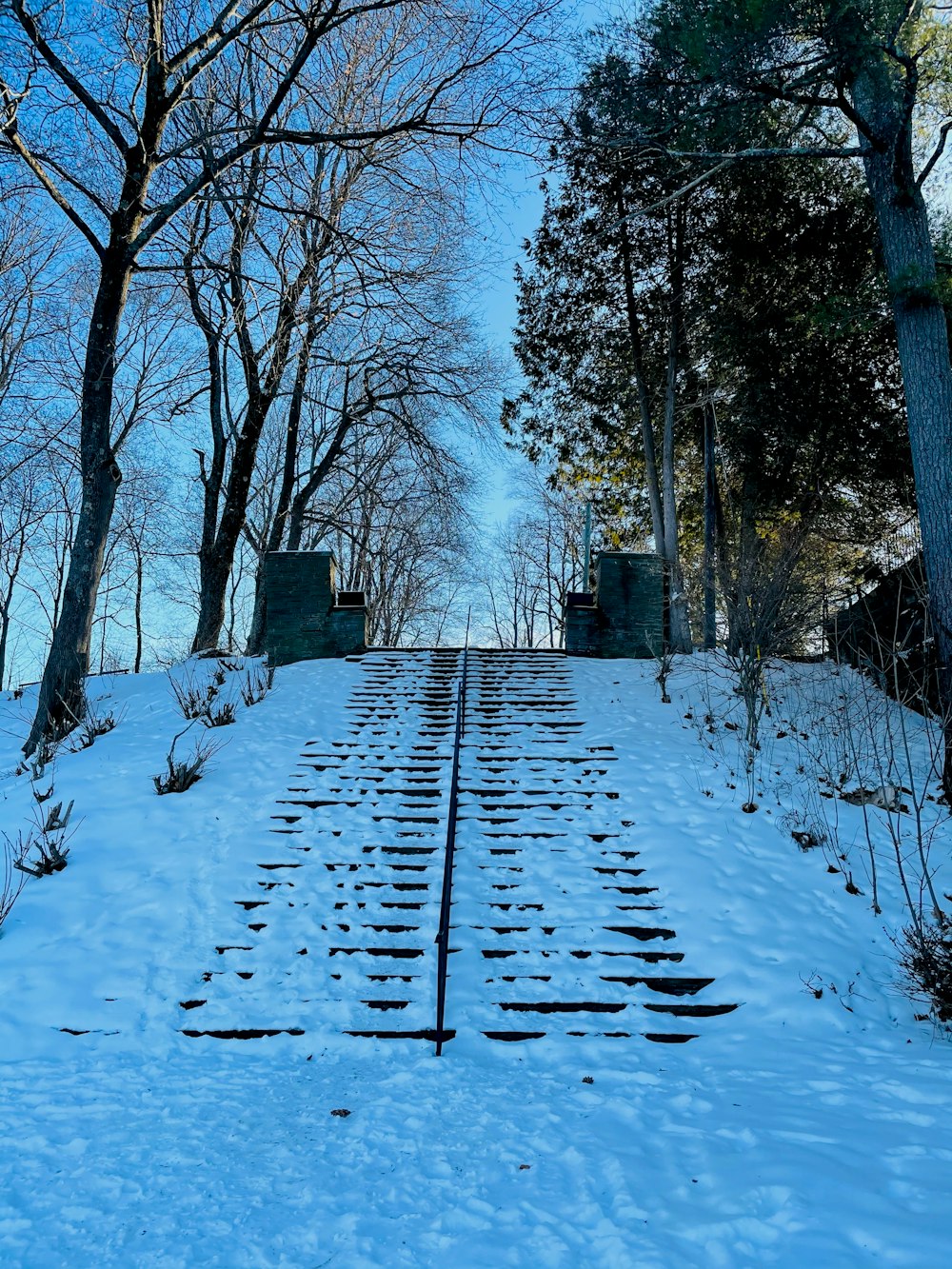 a train track in the middle of a snowy field