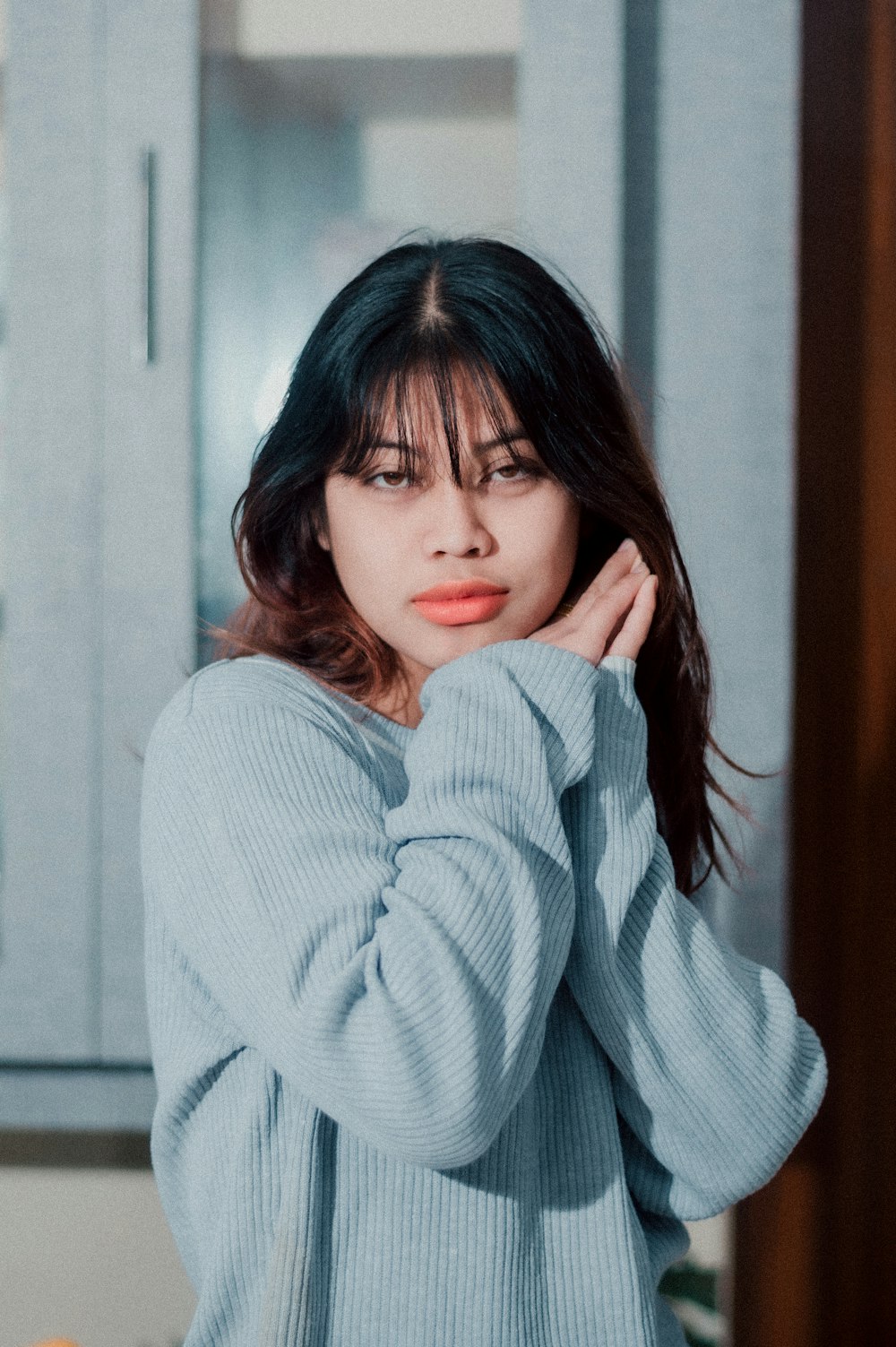 a woman in a blue sweater posing for a picture