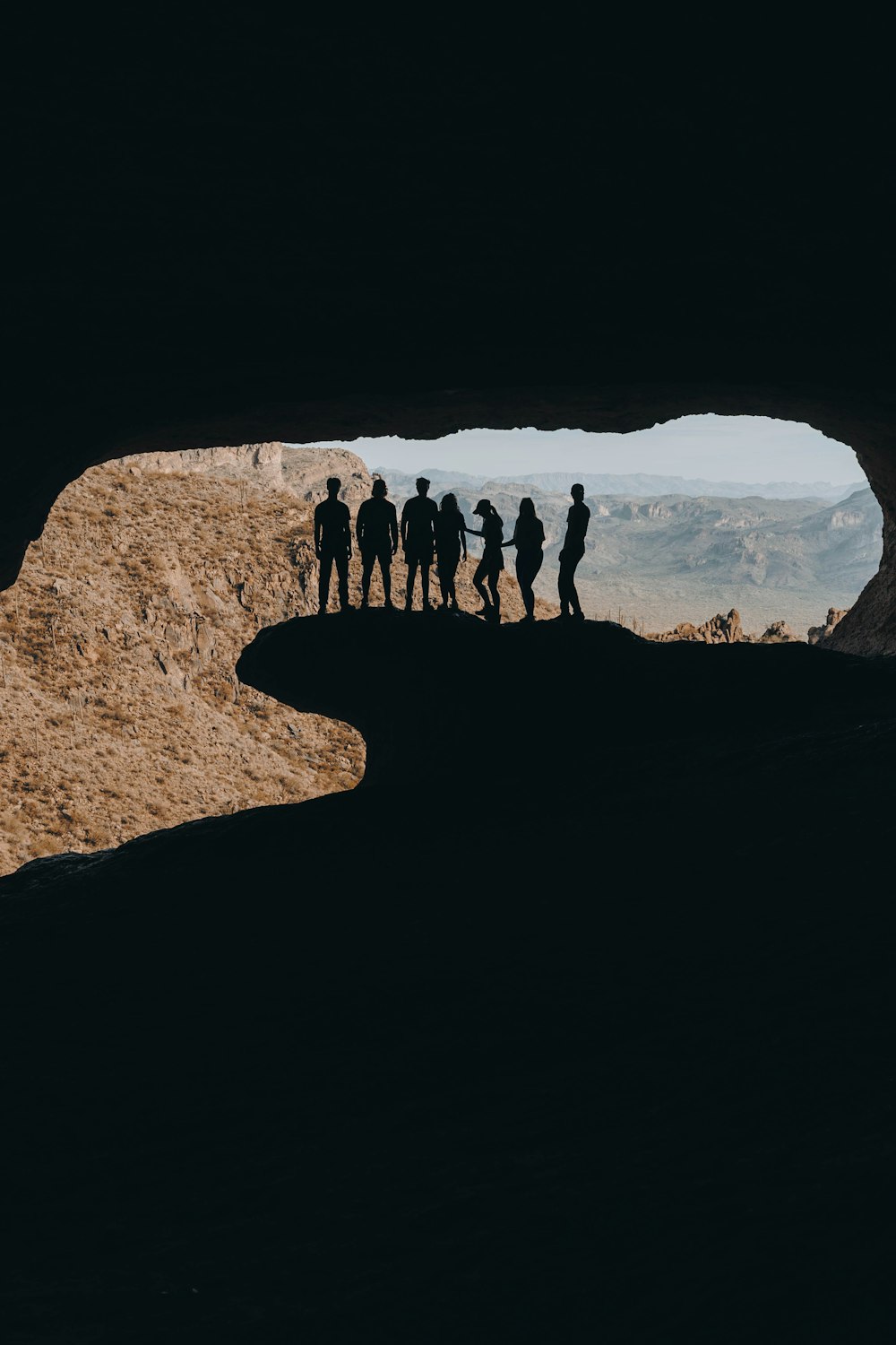 a group of people standing in a cave