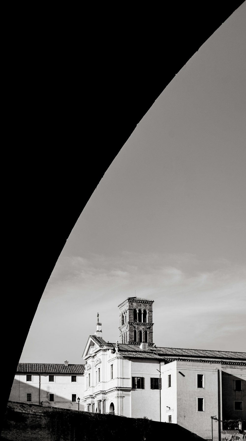 a black and white photo of a building with a clock tower