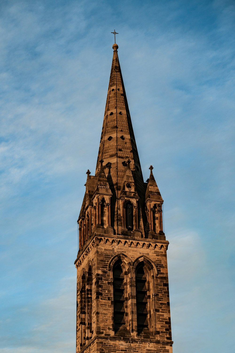 a tall tower with a cross on top of it