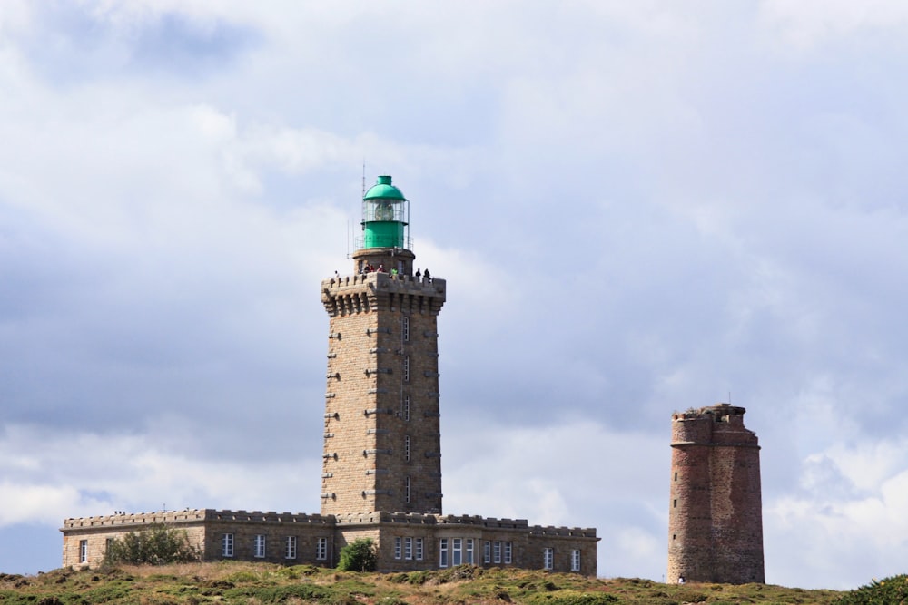 a tall tower sitting on top of a lush green hillside