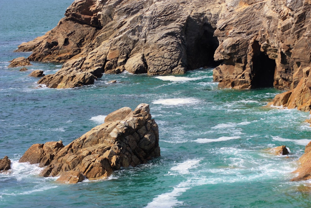 a large body of water next to a rocky shore