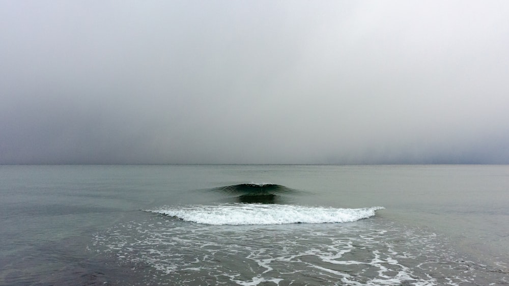 a large body of water with a wave coming in