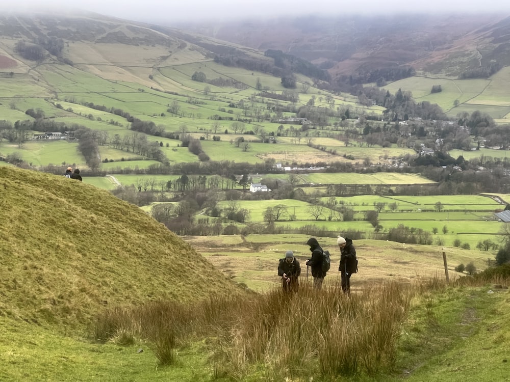 a group of people walking up a hill