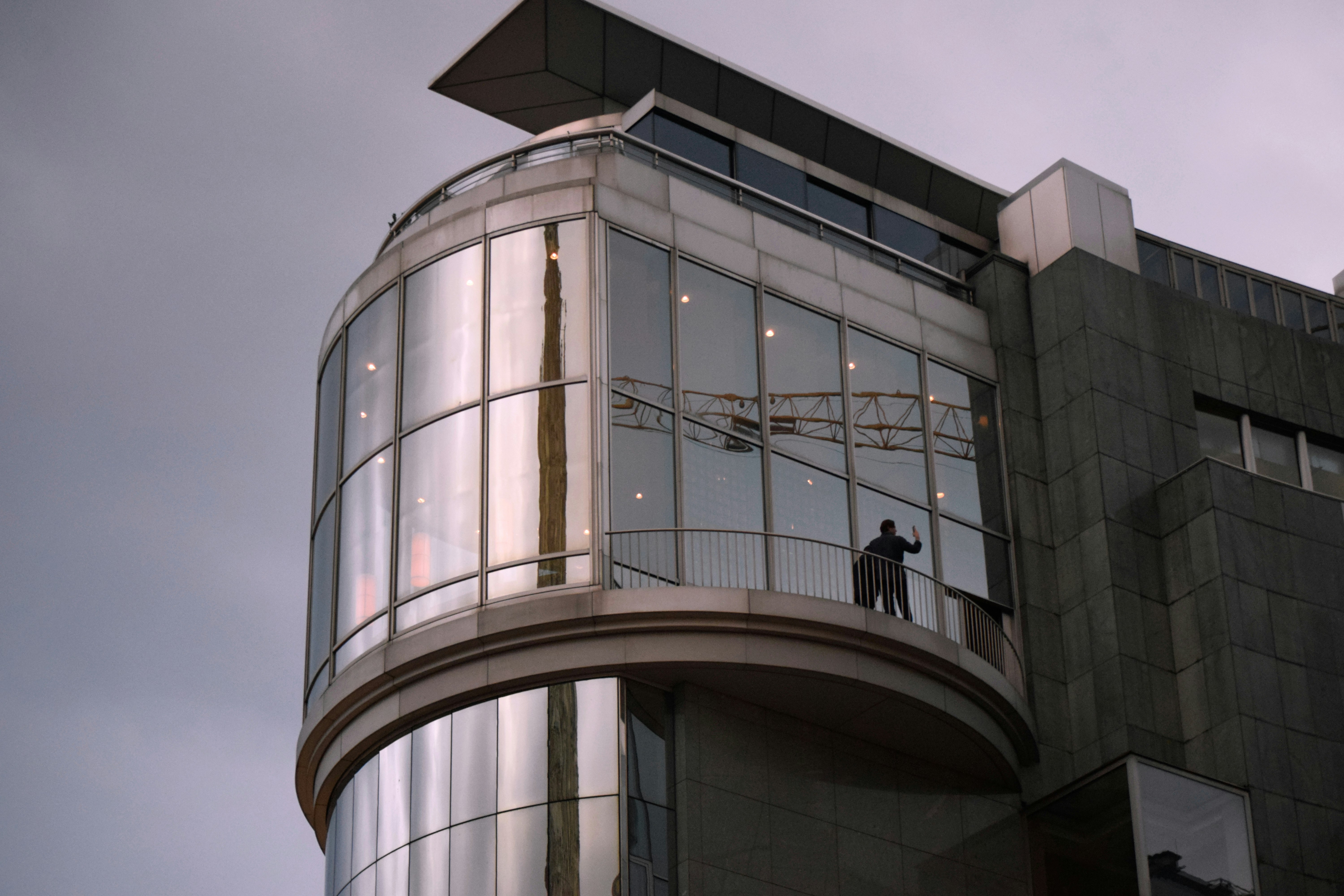 a man standing on a balcony of a building