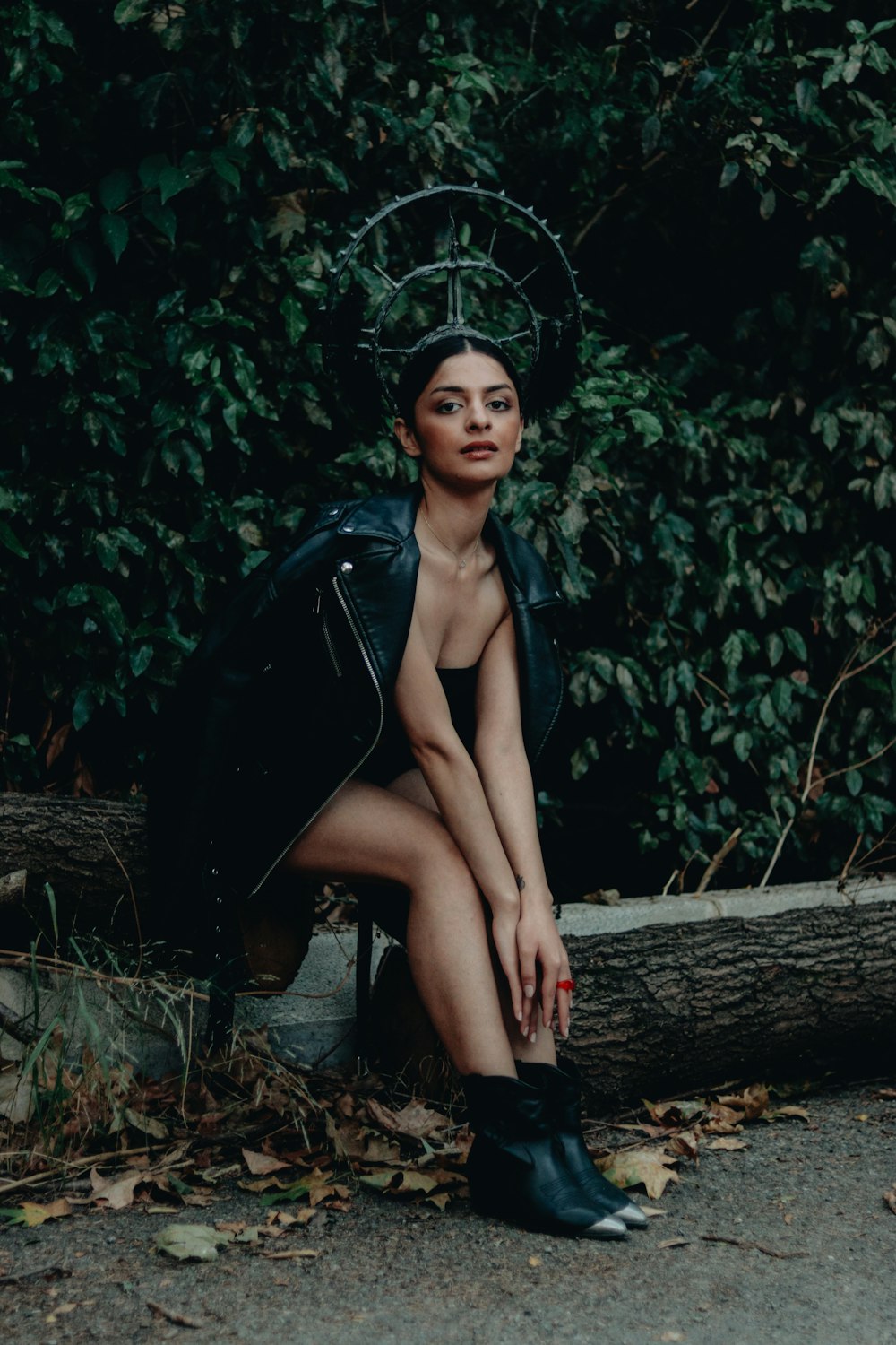 a woman sitting on a bench in front of a tree