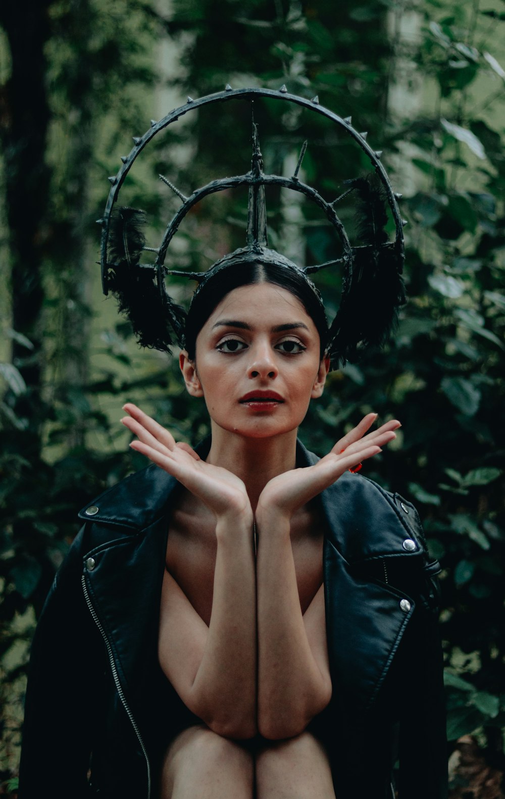 a woman in a black leather jacket with horns on her head