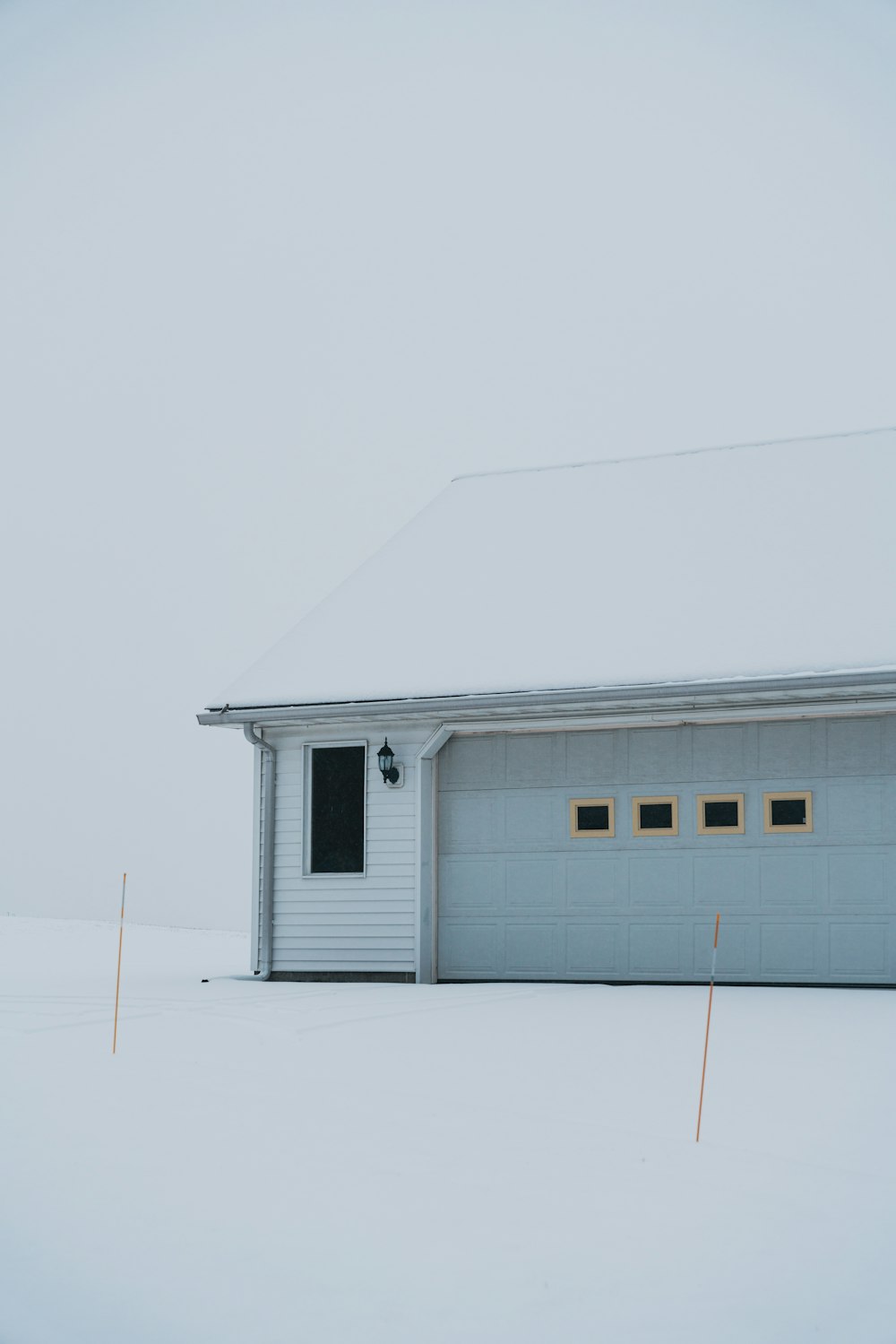 a garage in the middle of a snow covered field