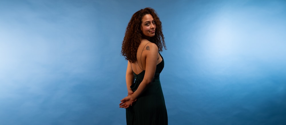 a woman in a black dress posing for a picture