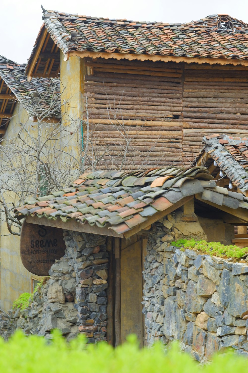 a building made of stone and wood with a clock on it