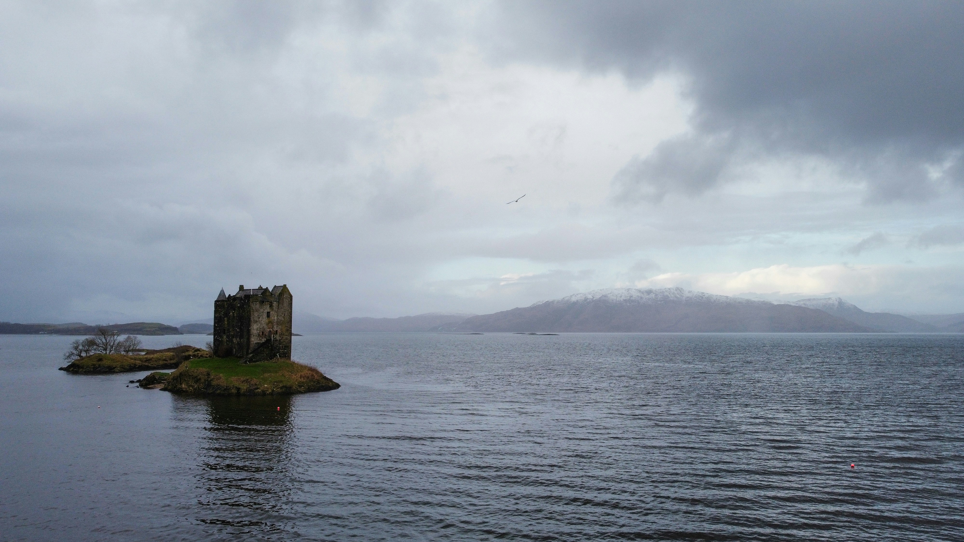 a large body of water with a castle in the middle of it