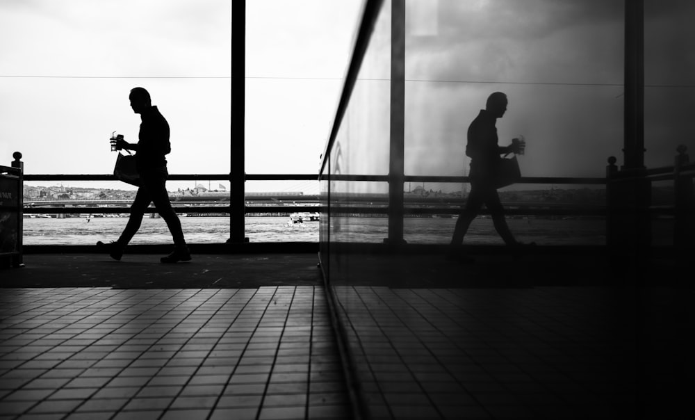 a couple of people walking across a walkway