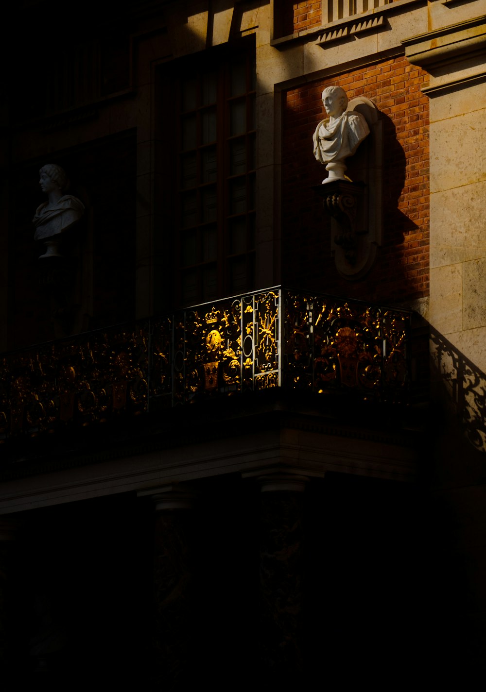a statue of a man on a balcony at night