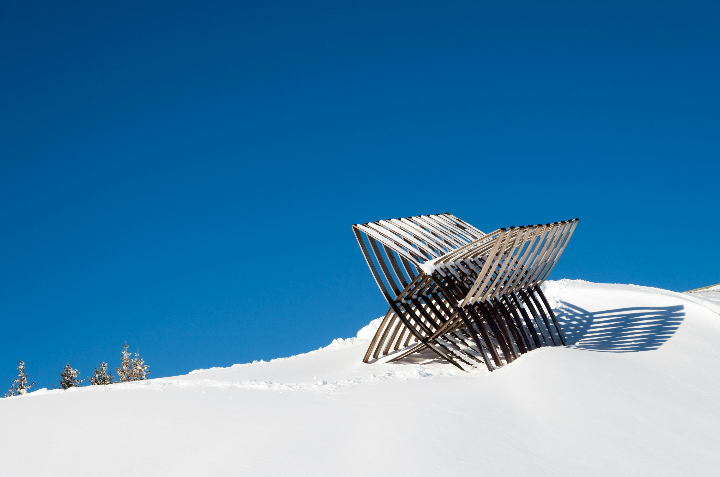 a wooden structure sitting on top of a snow covered slope