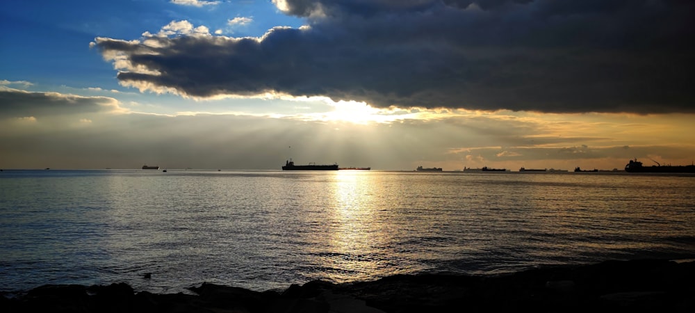 a large cargo ship in the distance on a body of water