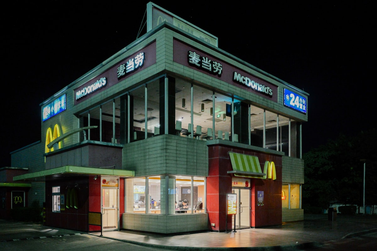 McDonald's restaurant location illuminated at night with the iconic golden arches sign