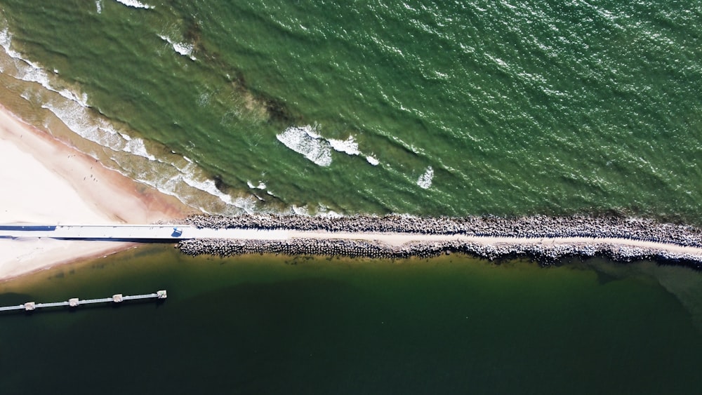 an aerial view of a beach and pier