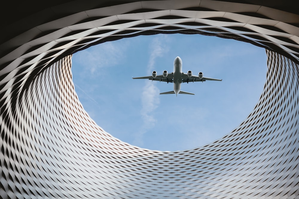 an airplane is flying through a circular structure
