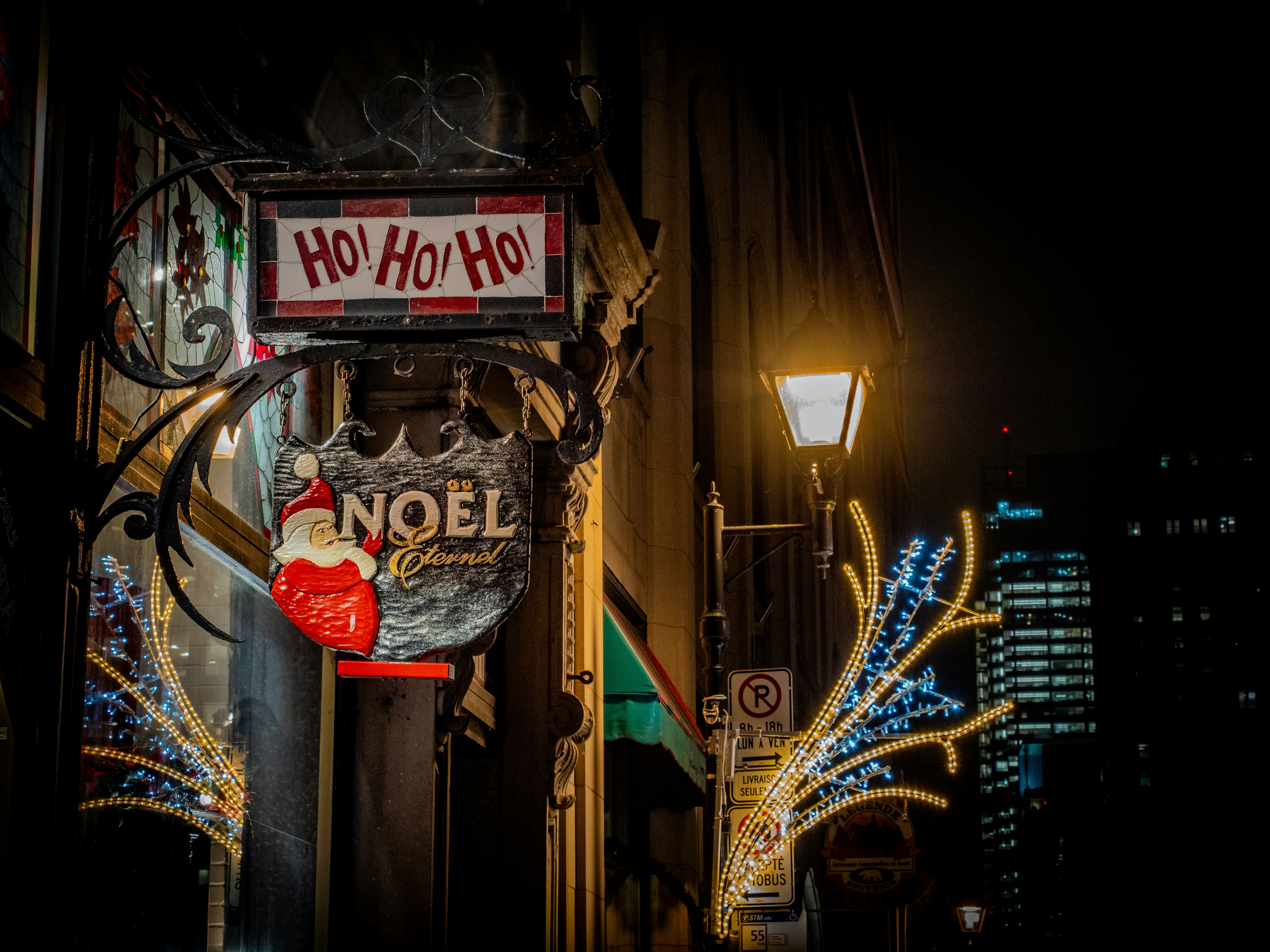 A sign that is hanging from the side of a building photo – Free Noel ...