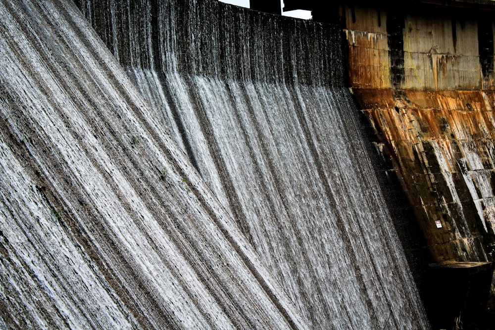 a man is standing in front of a dam