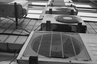 a row of air conditioners sitting on top of a tiled floor