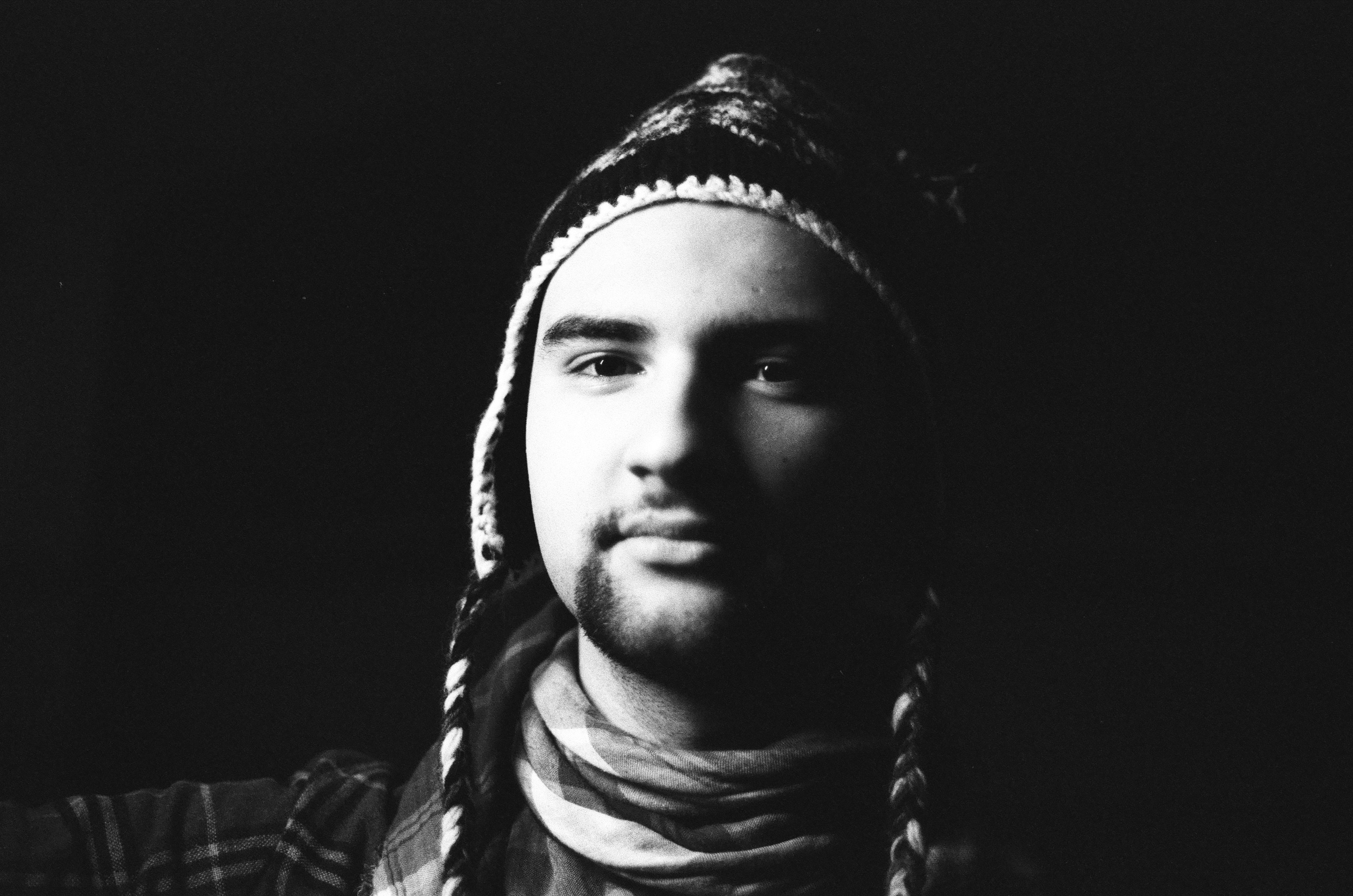Portrait of a guy in a winter hat and scarf. 2023 Canon FTb/ Canon FDn 50mm F1.8/ Rollei Superpan 200