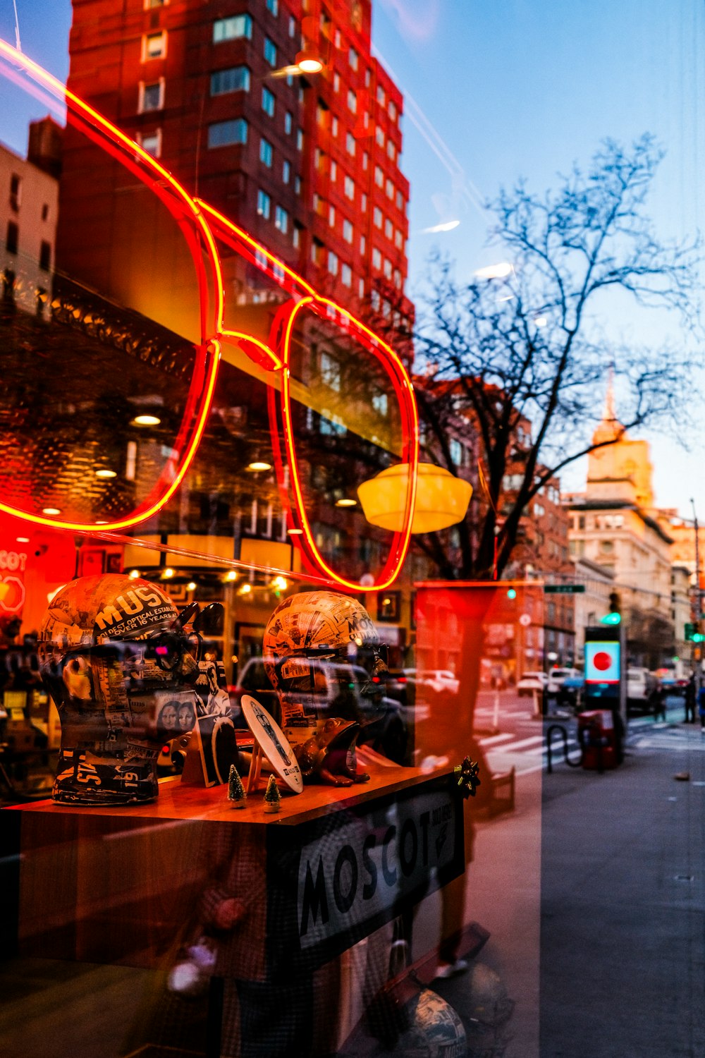 a store window with a pair of red glasses on display