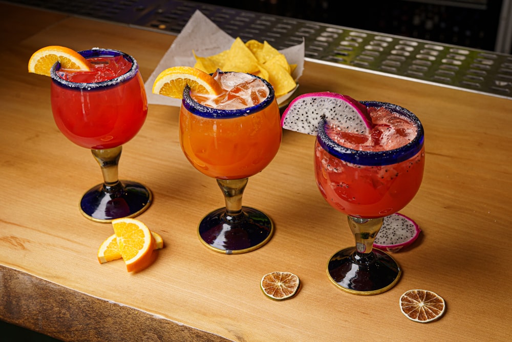 three different types of drinks on a table