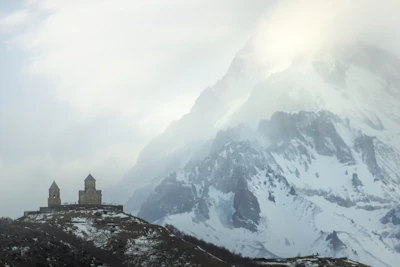 Mountain church beneath snowy peaks