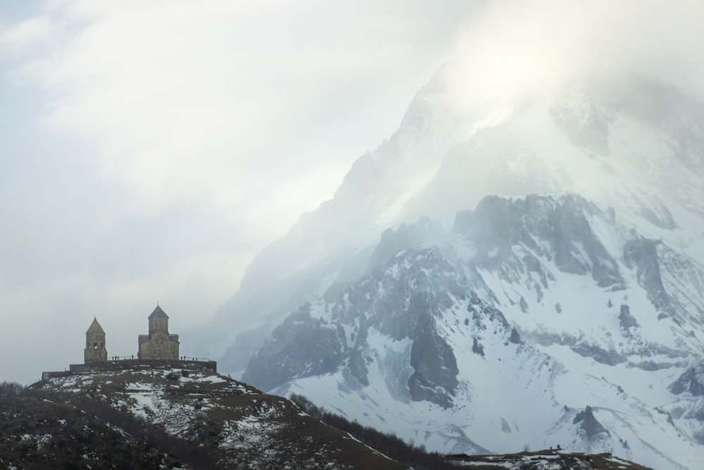 a snowy mountain with a church on top of it
