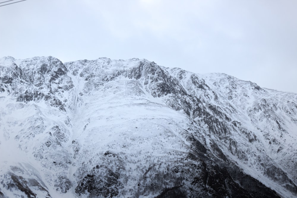 a snow covered mountain with a ski lift in the background