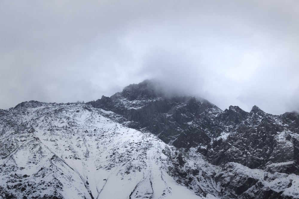 uma montanha coberta de neve e nuvens em um dia nublado