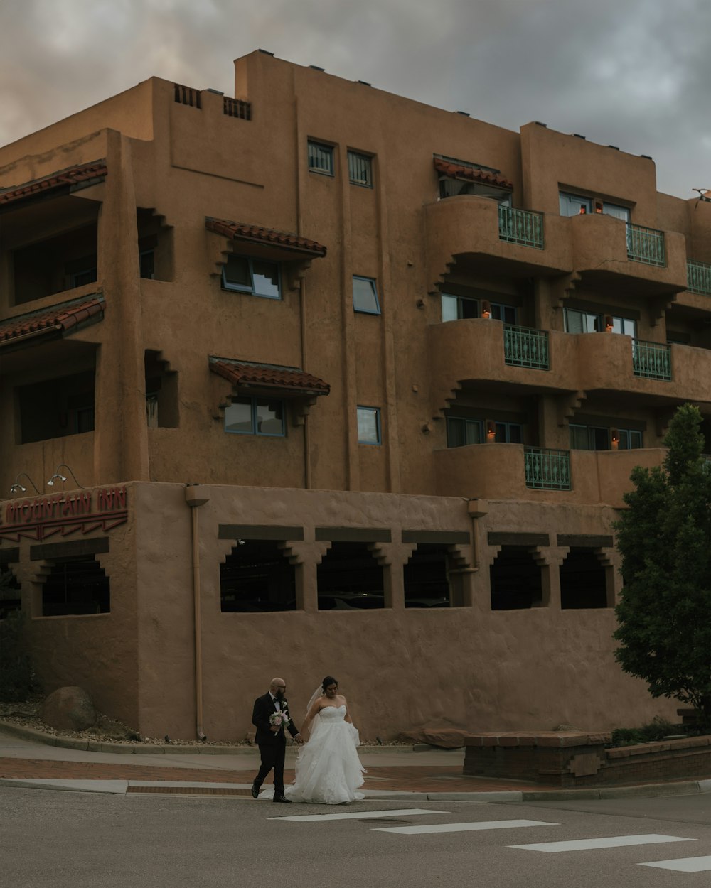 a bride and groom standing in front of a building